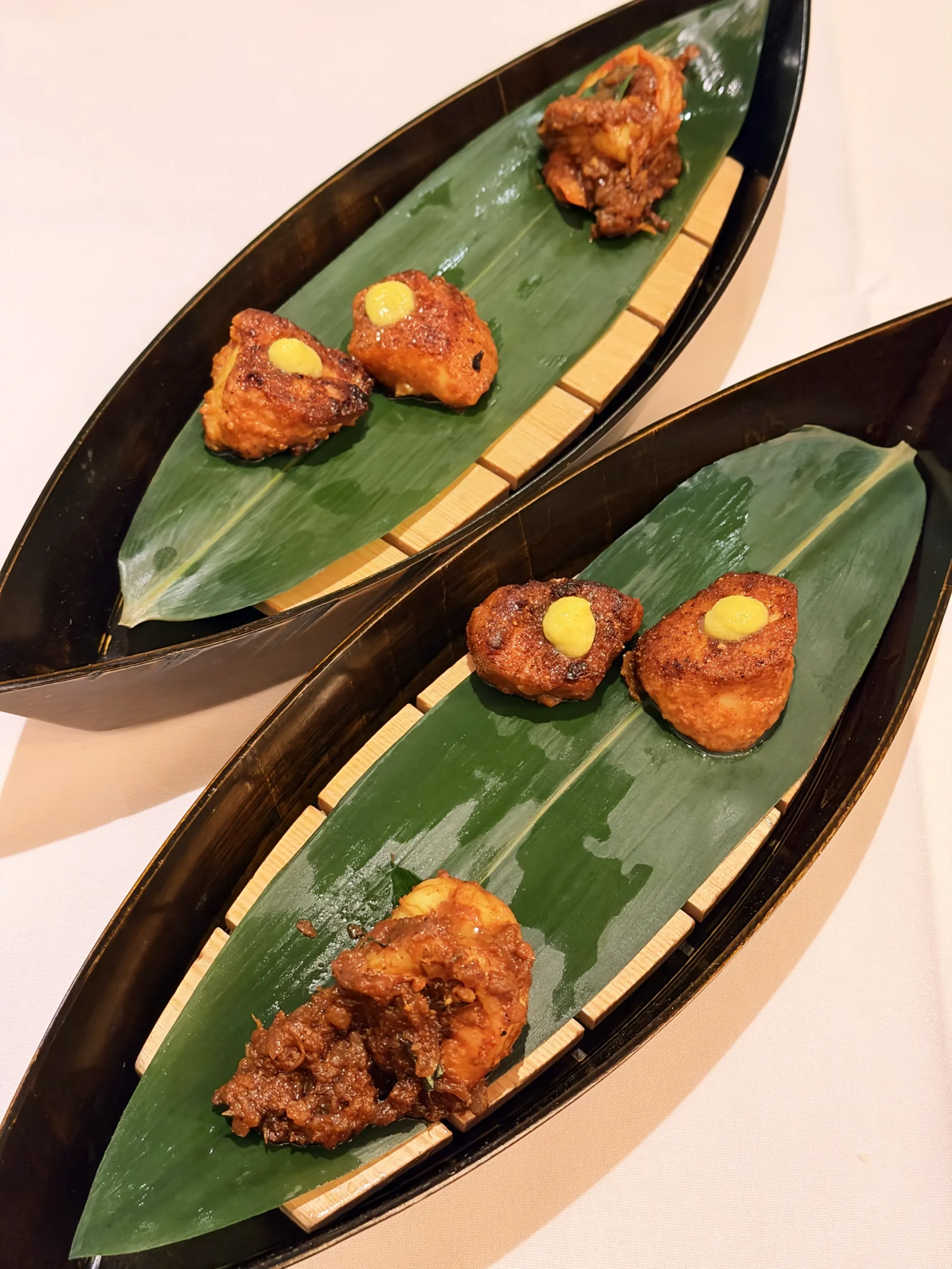 Succulent prawn roast prepared with onions, tomatoes, curry leaves, and traditional spices at Quilon London.