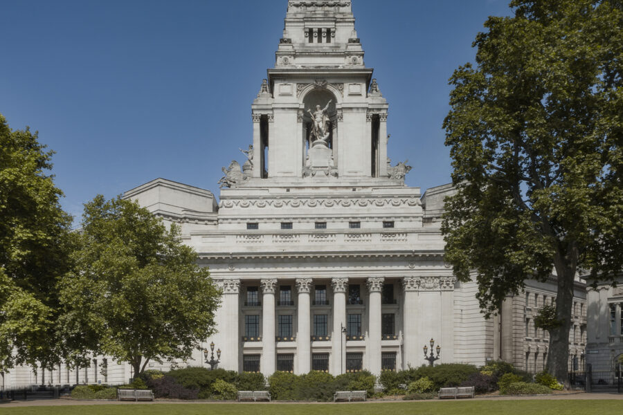 Exterior facade of the Four Seasons Hotel London at Ten Trinity Square, showcasing the majestic, historic architecture of this landmark building near the iconic Tower Bridge.
