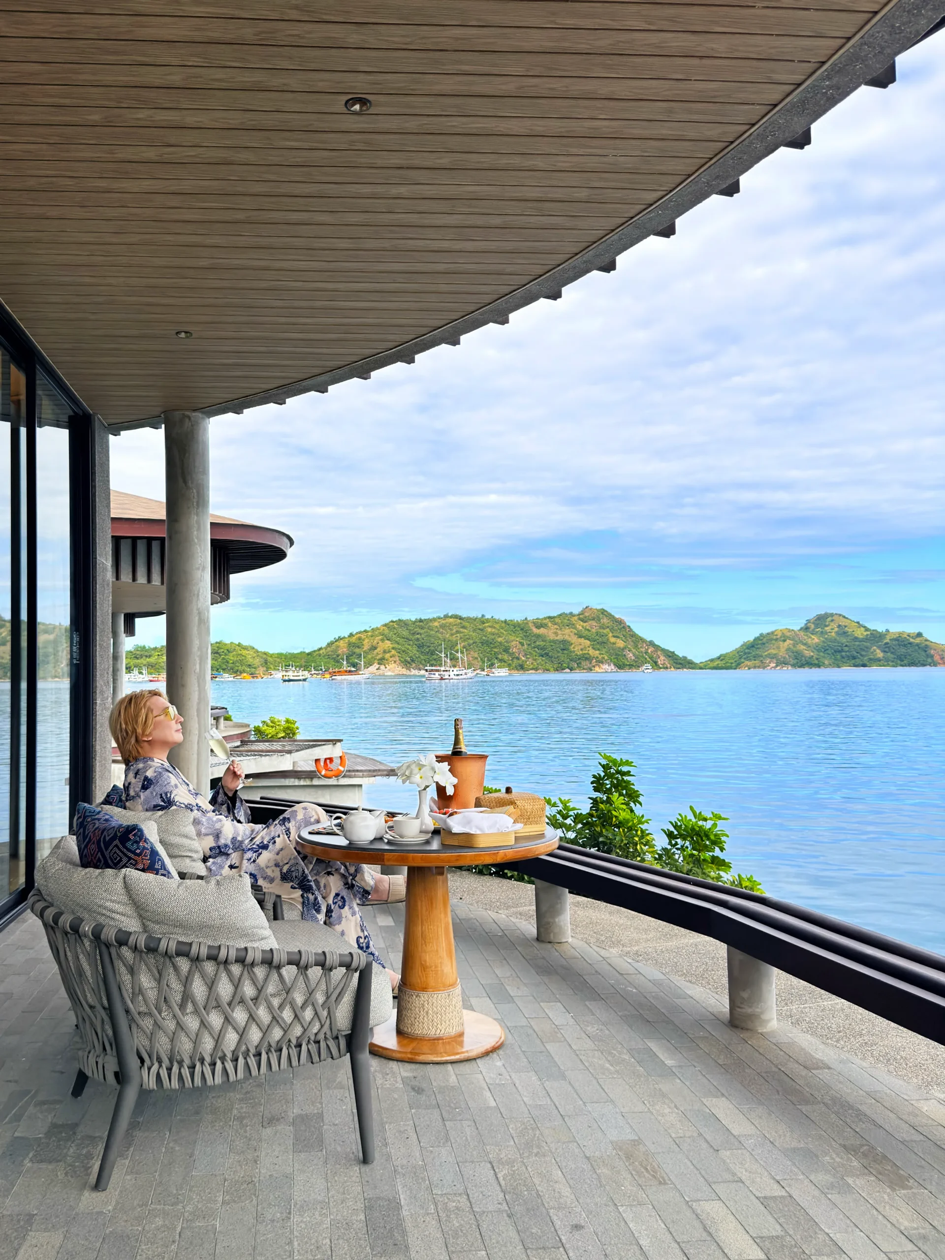 Stefano Malachi enjoying a luxurious in-villa breakfast on the private outdoor terrace of a Ta'aktana overwater villa, overlooking the calm turquoise ocean."