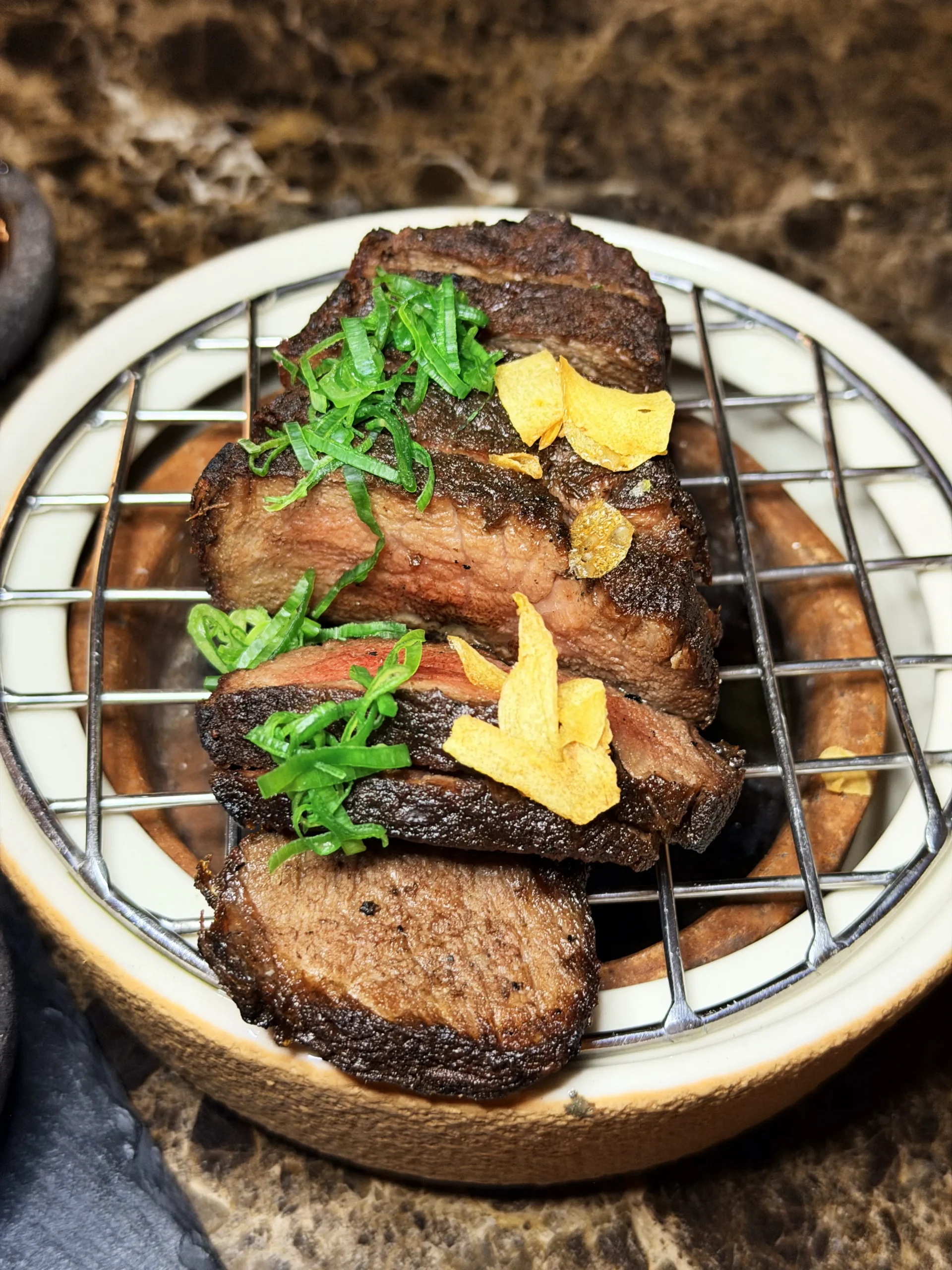 Expertly prepared Miyazaki Japanese A5 sirloin steak, grilled over traditional Binchotan charcoal for a perfect smoky sear.