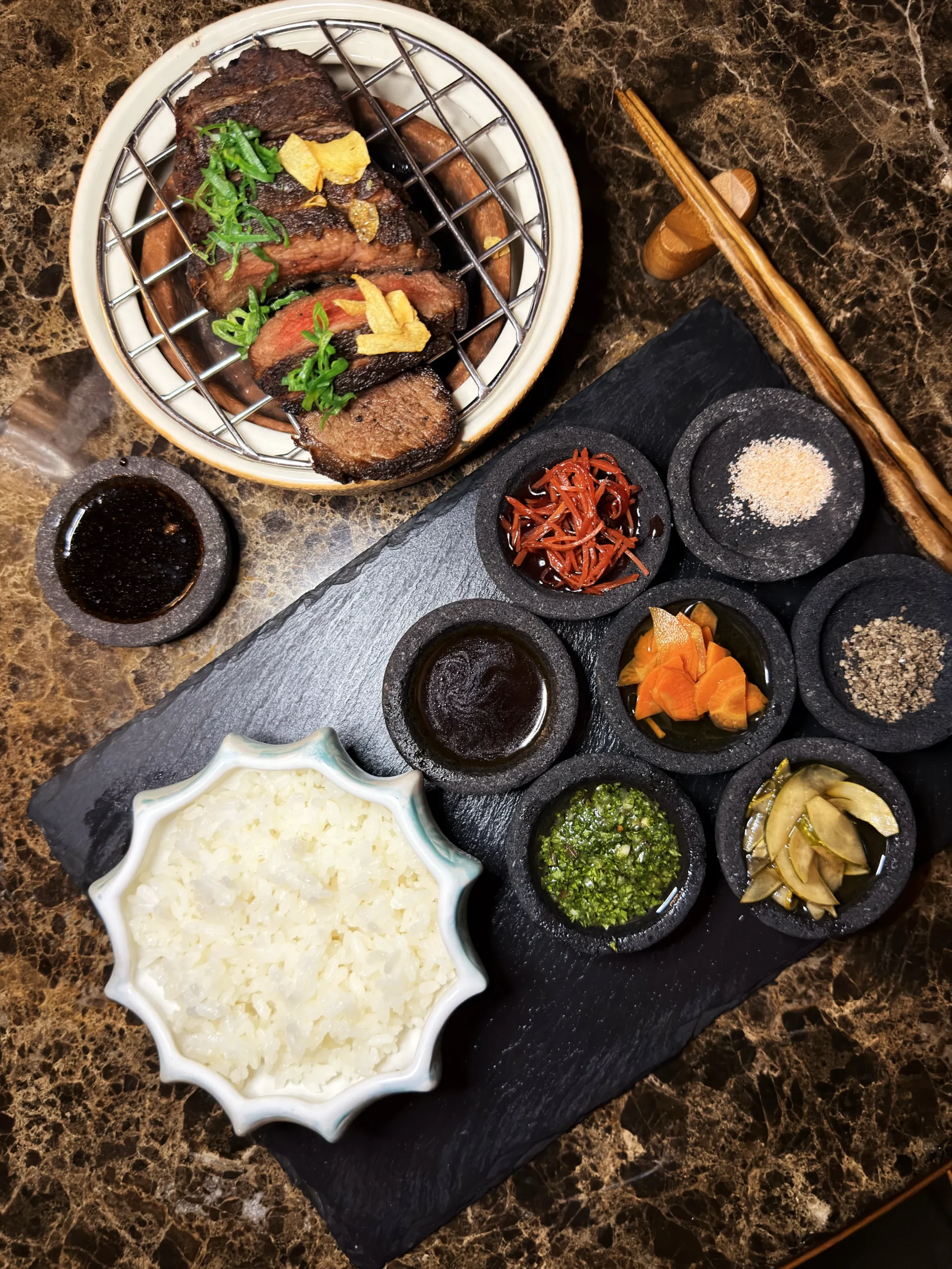 Gourmet Wagyu Tsukune skewers topped with seared foie gras, showcasing a rich and delicate texture at Ta'aktana's fine dining restaurant.