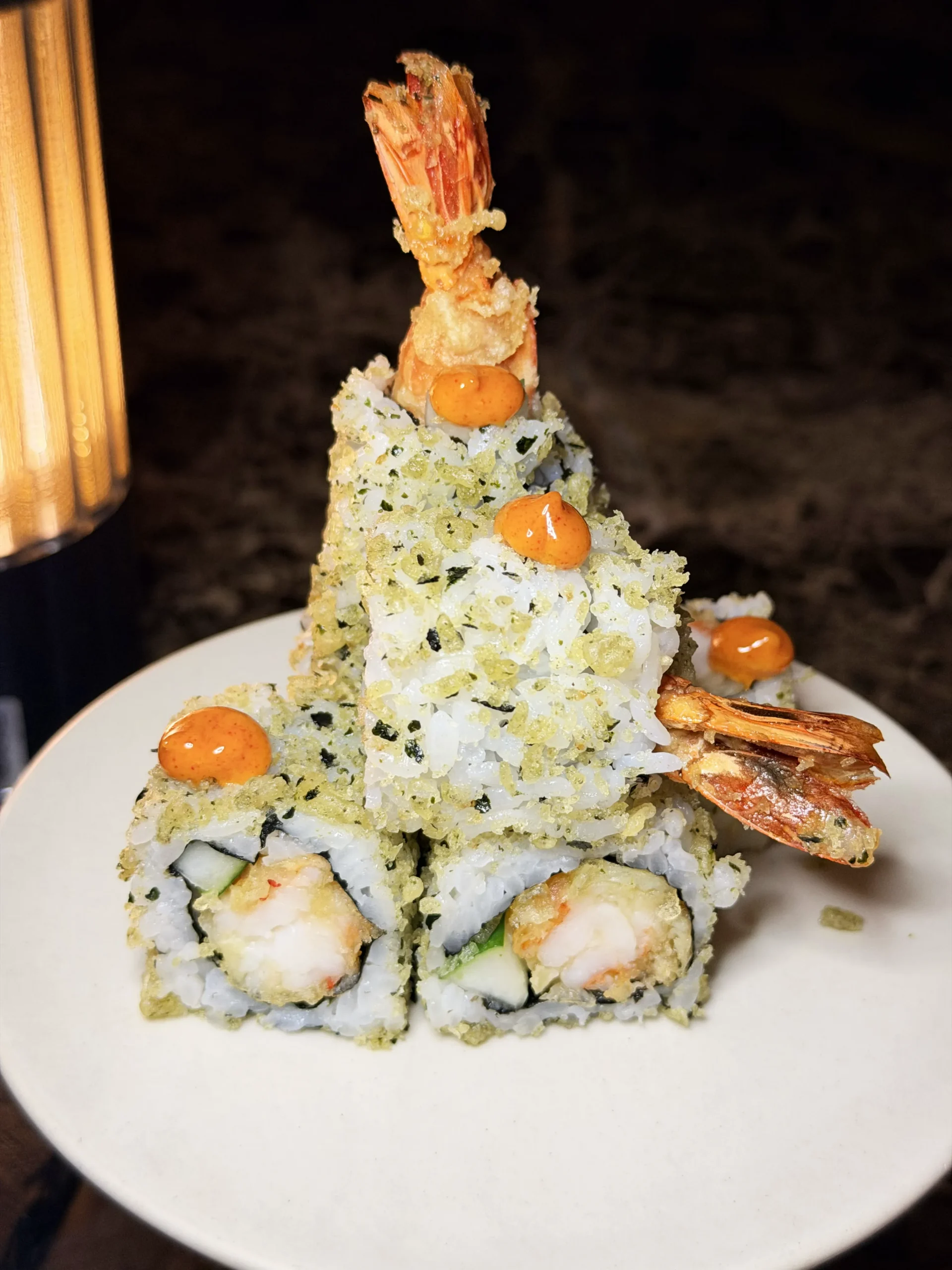 Artisanal Tempura Roll featuring crispy tiger prawn, fresh avocado, and savory takuan, drizzled with sweet soy and torched aburi mayonnaise.