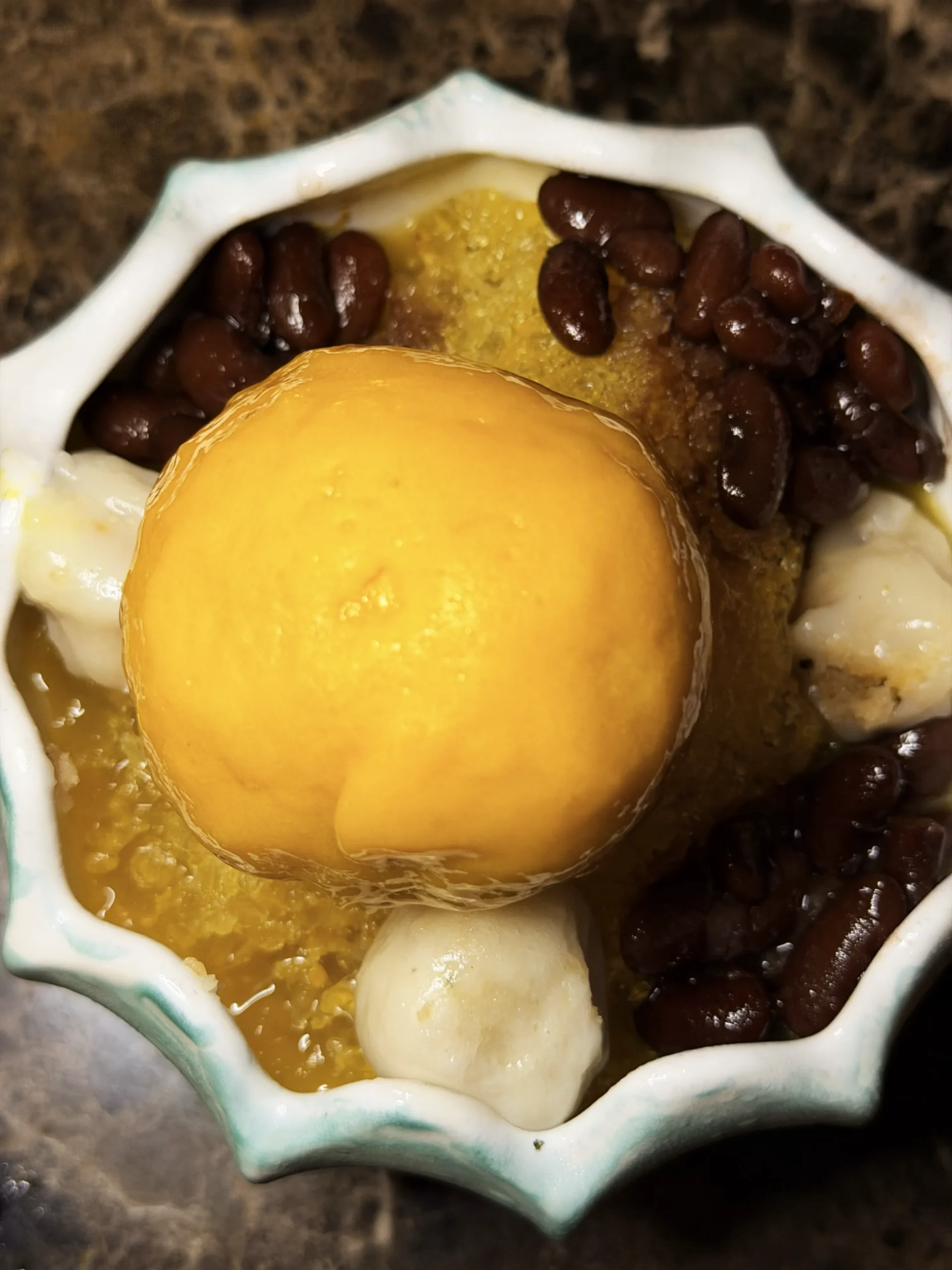 Refreshing Mango Kakigori, a delicate Japanese shaved ice dessert topped with vibrant fresh mango and elegant garnishes.