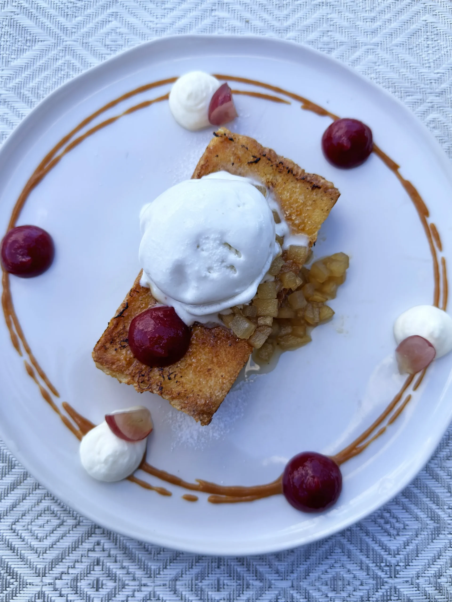 Golden-brown French toast served with garnish, presented as a gourmet breakfast dish at Leros.