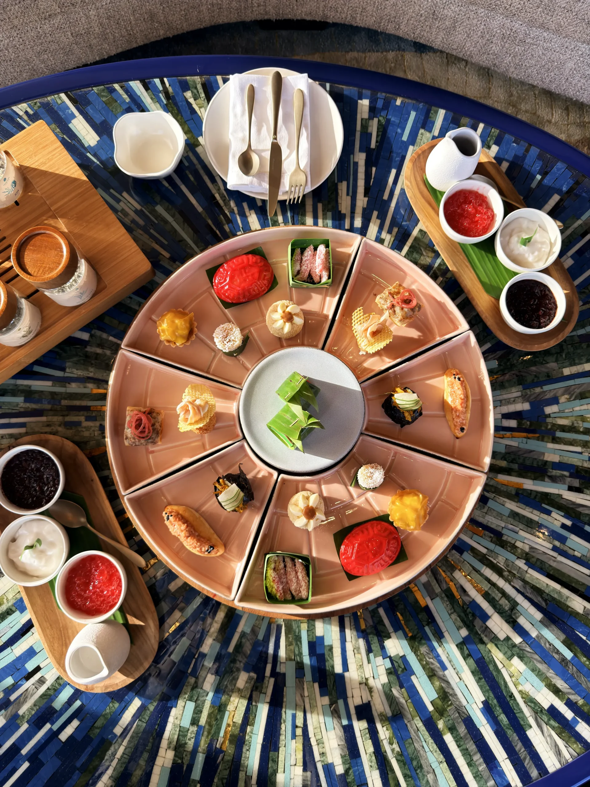 A gourmet display of delicate artisanal sweets and savory pastries, beautifully presented for afternoon tea service at Nera Lounge.