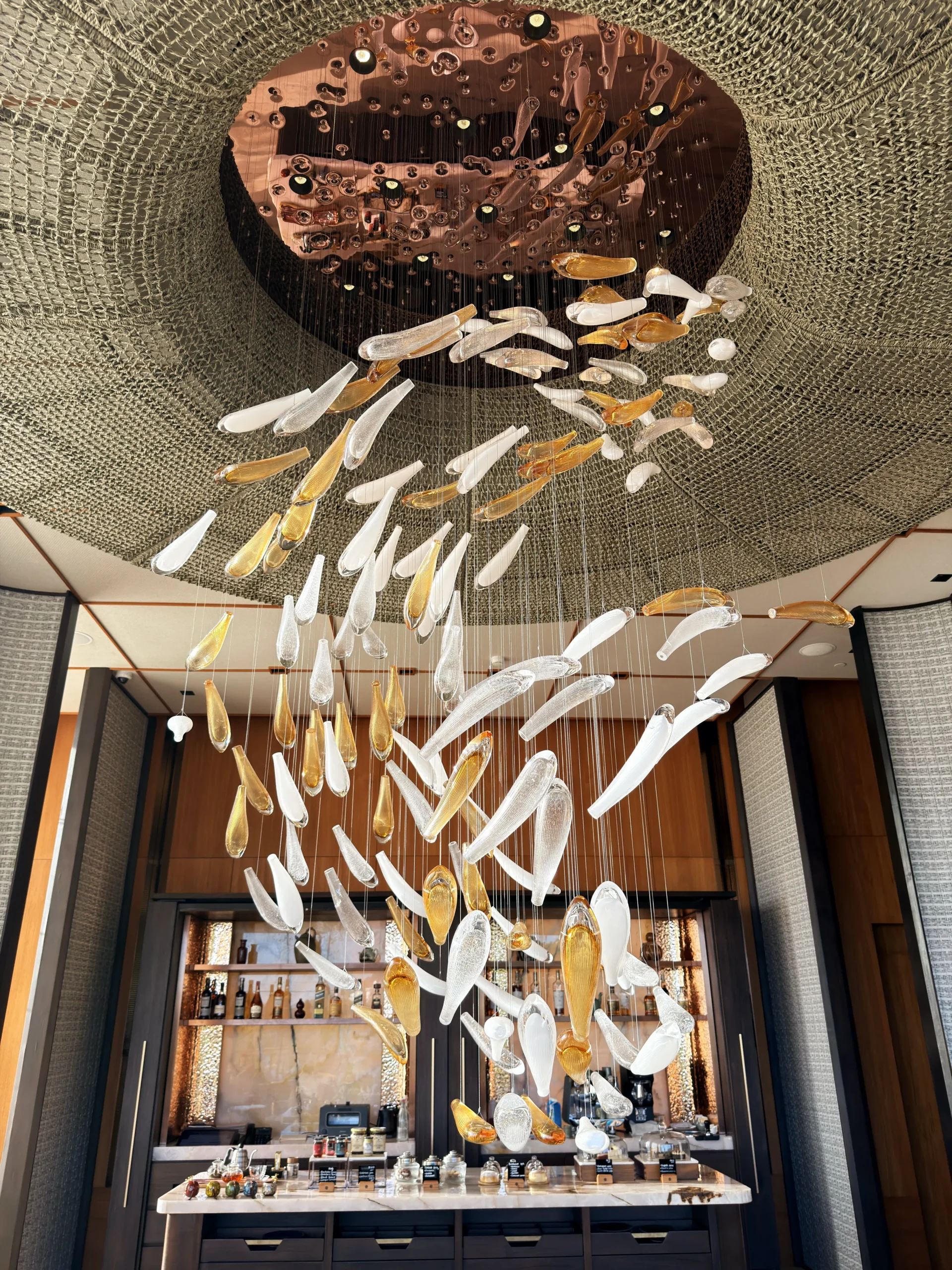 Sophisticated interior design of Nera Lounge, featuring ambient lighting, refined furnishings, and unique decorative floating koi fish art installations.