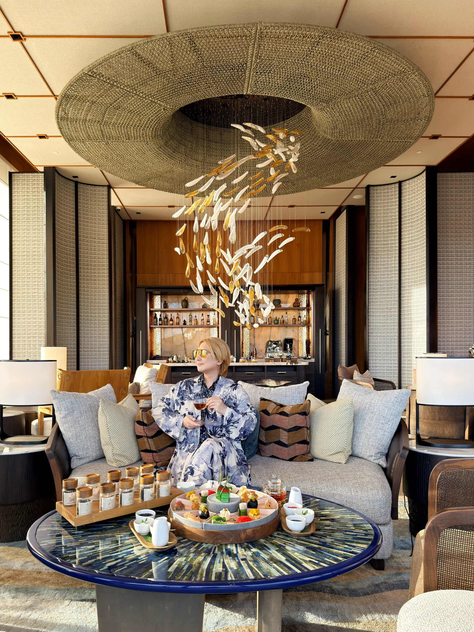 Stefano Malachi enjoying a refined afternoon tea service at Nera Lounge, situated within the elegant Ta'aktana, a Luxury Collection Resort.