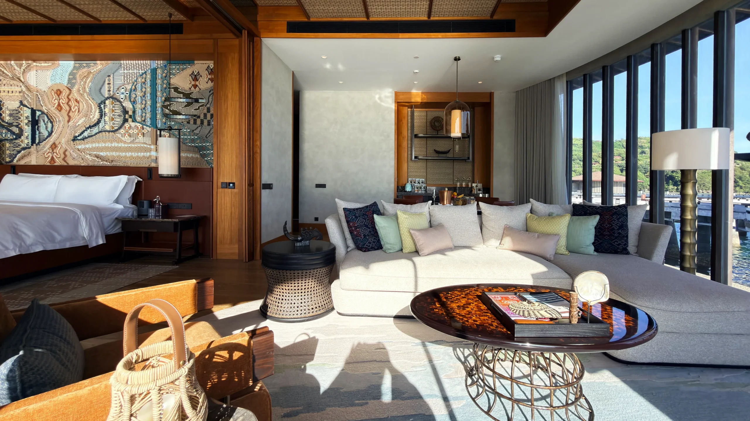 Plush master bedroom suite in a Ta'aktana overwater villa, styled with refined craftsmanship, premium linens, and direct views of the turquoise ocean.