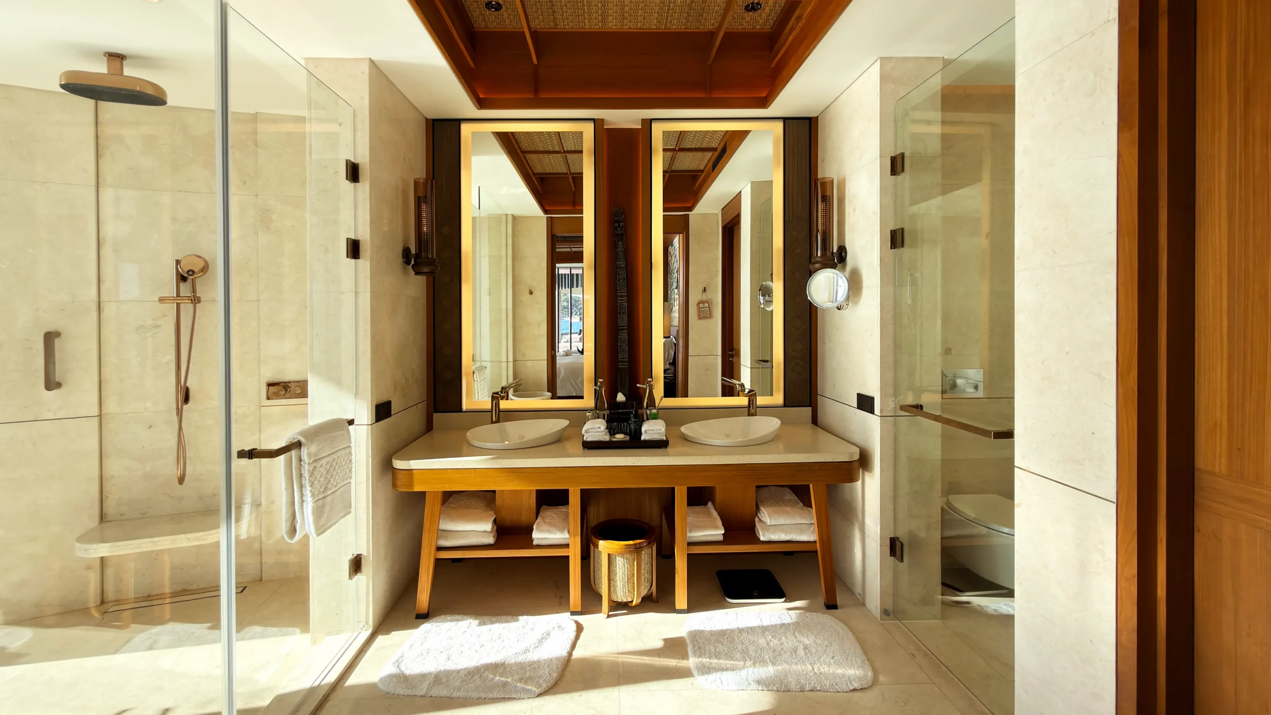 Elegant bathroom inside a Ta'aktana overwater villa, featuring a freestanding deep-soaking tub positioned for uninterrupted views of the open ocean.