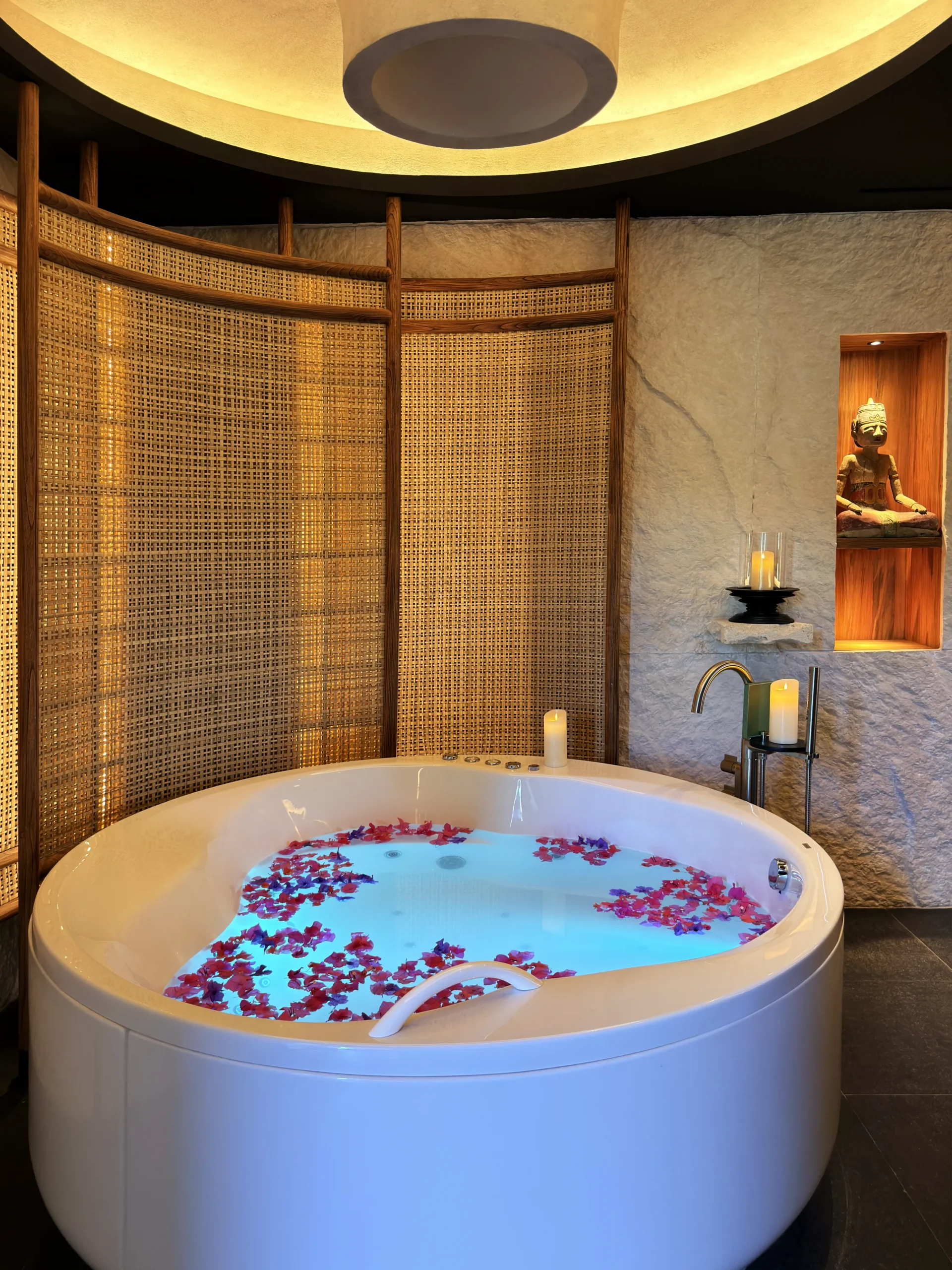 Close-up of a curated spa bathtub ritual at Di'A Spa, highlighting aromatic botanical elements and essential oils designed for deep relaxation