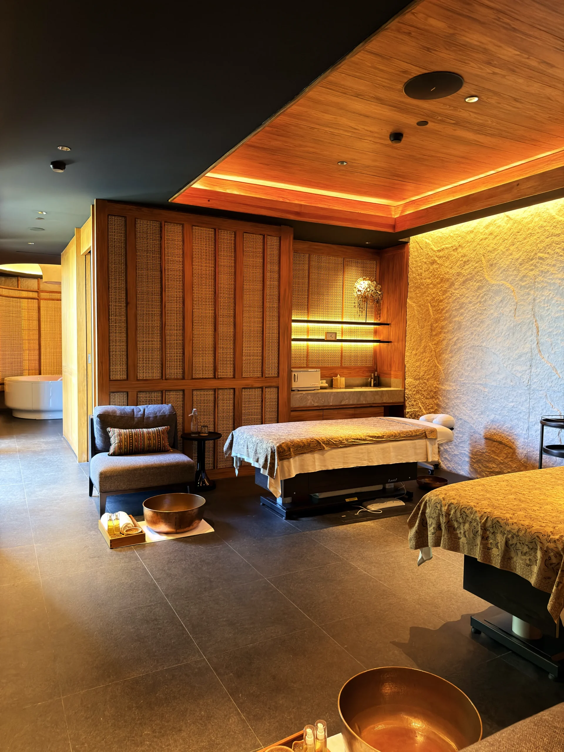 Private Di'A Spa treatment suite featuring double massage beds and an intimate soaking bathtub for a tailored, luxury wellness journey.