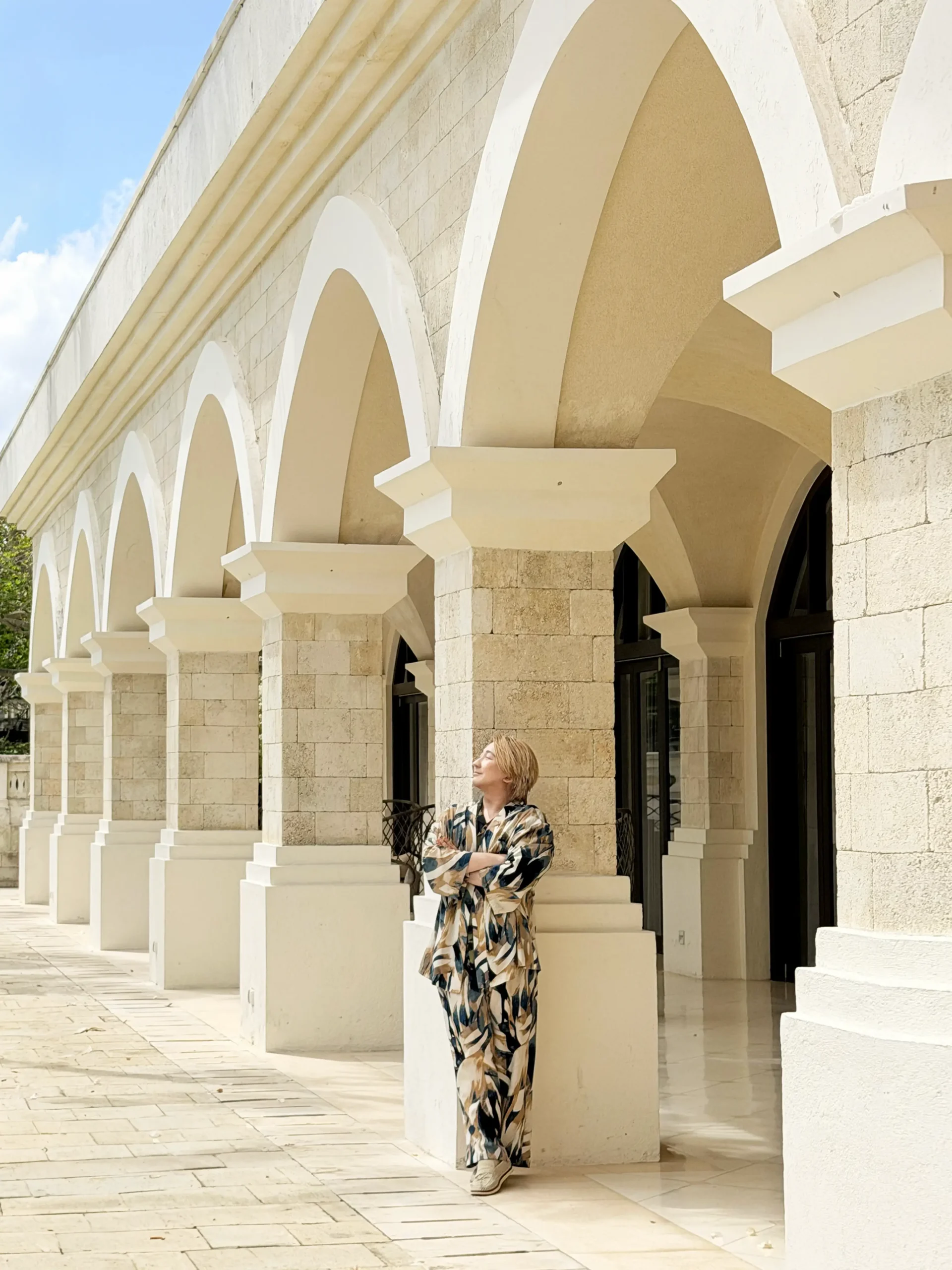 Stefano Malachi standing against the majestic Hindu-Javanese water palace architecture and intricate stone carvings at Jumeirah Bali.
