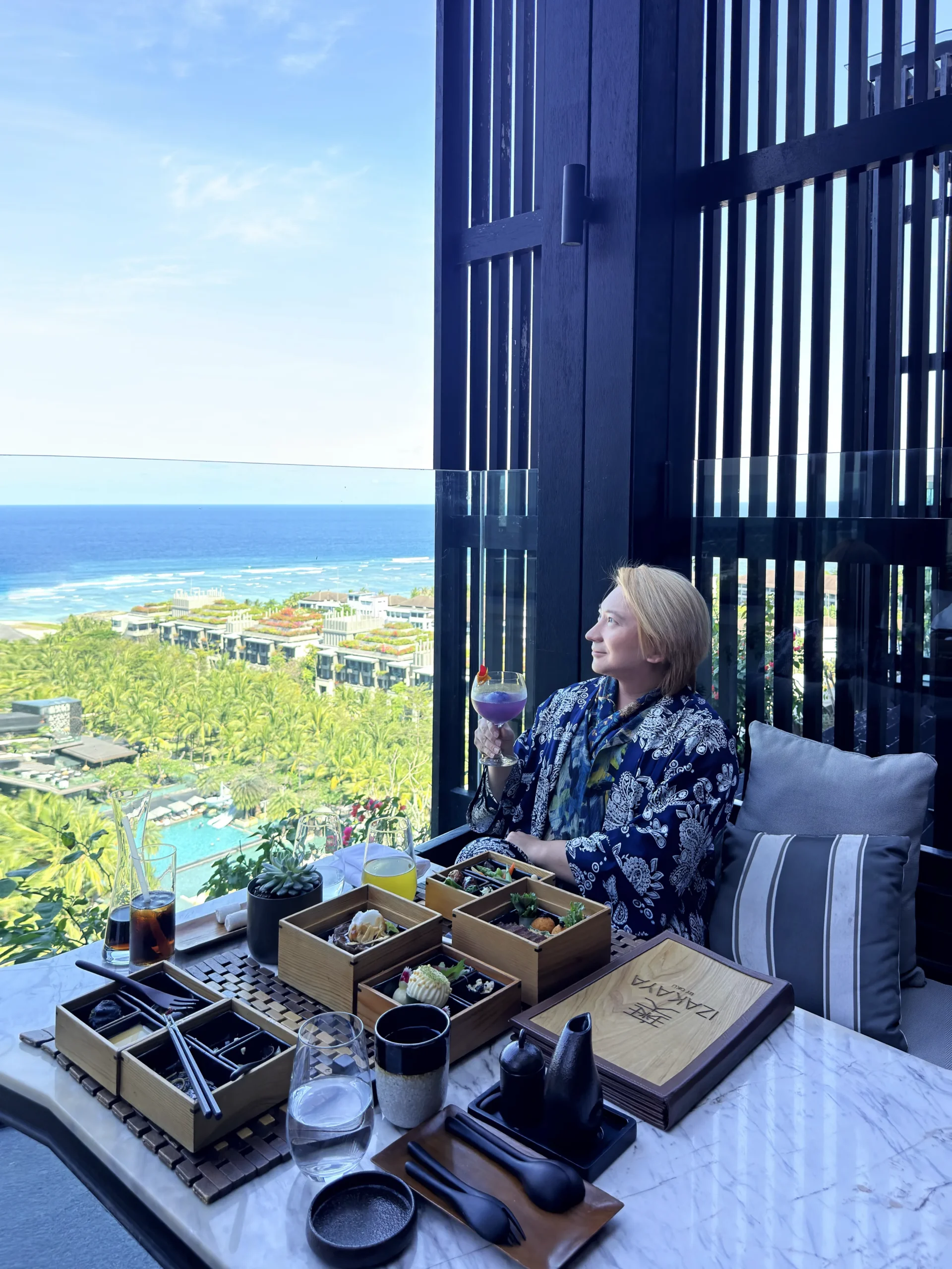 Stefano Malachi experiencing modern Japanese dining at Izakaya by OKU within The Apurva Kempinski Bali, highlighting the chic bistro setting and culinary craftsmanship.