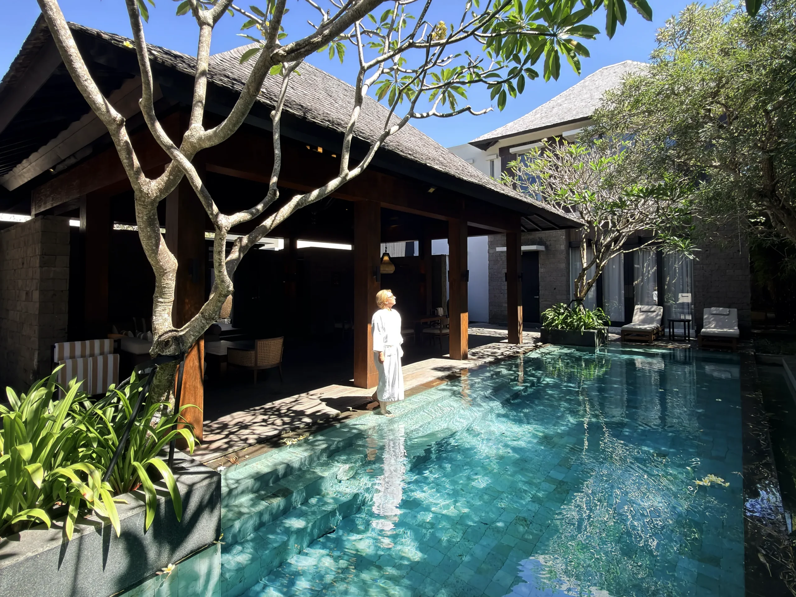 Stefano Malachi experiencing the ultra-luxurious Majapahit 3 Bedroom Villa at The Apurva Kempinski Bali, showcasing the expansive private pool and palatial estate architecture.