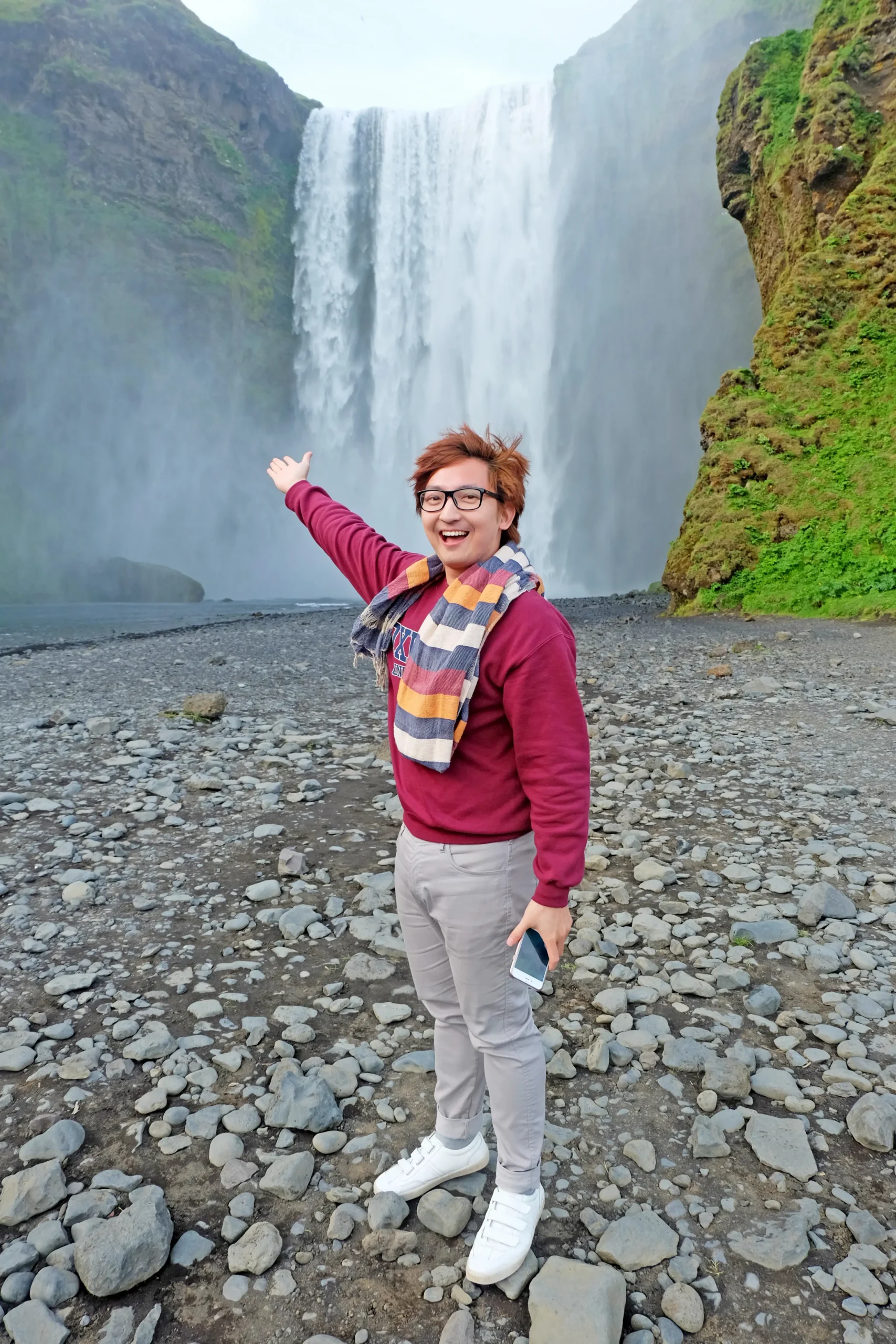 Text: Stefano Malachi experiencing the majestic Seljalandsfoss waterfall in the municipality of Rangárþing eystra, Iceland, capturing a breathtaking moment of high-end adventure travel.